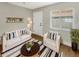 Cozy living room with a white couch, wood floors, decorative shelves, and natural light from the windows at 961 Charlotte Ave, Sarasota, FL 34237