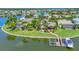 Waterfront home with lush landscaping, a backyard pool, and a private dock on a serene lake at 5405 Merritt Island Dr, Apollo Beach, FL 33572