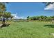 Expansive backyard with lush green lawn, perfect for outdoor activities and entertaining with waterfront views at 5405 Merritt Island Dr, Apollo Beach, FL 33572