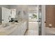 Bathroom features a double sink vanity, tile floors, and a view of the water at 5405 Merritt Island Dr, Apollo Beach, FL 33572