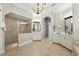 Spacious bathroom with walk-in shower, dual vanities, and neutral tile at 5405 Merritt Island Dr, Apollo Beach, FL 33572