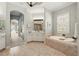 Elegant bathroom with arched entry, soaking tub, vanity, and tranquil lighting at 5405 Merritt Island Dr, Apollo Beach, FL 33572