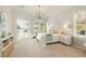 Serene bedroom with plantation shutters, a modern chandelier, and a view of the pool area at 5405 Merritt Island Dr, Apollo Beach, FL 33572