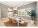 Bright dining room featuring a white table, wicker chairs, and modern light fixture at 5405 Merritt Island Dr, Apollo Beach, FL 33572