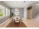 Elegant dining area with a white table and seating, enhanced by natural light from shuttered windows at 5405 Merritt Island Dr, Apollo Beach, FL 33572