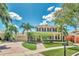 Two-story home with covered porch, lush landscaping, circular driveway, and mailbox at 5405 Merritt Island Dr, Apollo Beach, FL 33572