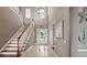 Spacious foyer with high ceilings, staircase, and tiled floor with decorative inlay at 5405 Merritt Island Dr, Apollo Beach, FL 33572