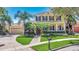 Beautiful two-story home with a well-manicured lawn, front porch, attached garage and tropical landscaping at 5405 Merritt Island Dr, Apollo Beach, FL 33572