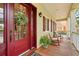 Charming front porch featuring rocking chairs and a decorative wreath on the front door at 5405 Merritt Island Dr, Apollo Beach, FL 33572