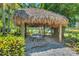 Tranquil gazebo with a thatched roof, a perfect shady spot for relaxation and enjoying the surroundings at 5405 Merritt Island Dr, Apollo Beach, FL 33572