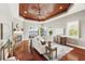 Open living room with hardwood floors, a fireplace, and water views from large windows at 5405 Merritt Island Dr, Apollo Beach, FL 33572