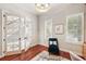 Bright home office with French doors, wood floors, plantation shutters, and comfortable seating at 5405 Merritt Island Dr, Apollo Beach, FL 33572
