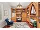 Home office with custom wood built-ins, cherry floors, a modern desk, and comfortable seating at 5405 Merritt Island Dr, Apollo Beach, FL 33572