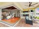 Spacious covered patio with ceiling fans and an outdoor kitchen, seamlessly connected to the indoor living area at 5405 Merritt Island Dr, Apollo Beach, FL 33572