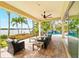Covered outdoor patio with comfortable seating, offering a tranquil view of the lush garden and pool area at 5405 Merritt Island Dr, Apollo Beach, FL 33572