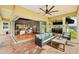 Covered patio featuring comfortable seating, an outdoor kitchen, and views of the water and surrounding landscape at 5405 Merritt Island Dr, Apollo Beach, FL 33572