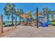 Community playground featuring swings, slides, and shaded areas near a lake at 5405 Merritt Island Dr, Apollo Beach, FL 33572
