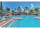 Community pool featuring lap lanes, slides, lounge chairs, and tropical landscaping, great for Gathering fun and relaxation at 5405 Merritt Island Dr, Apollo Beach, FL 33572