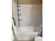 Bathroom with white tiled shower and shelving unit at 8653 Fancy Finch Dr # 102, Tampa, FL 33614