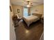 Comfortable bedroom featuring a ceiling fan, wood flooring, and a warm, inviting ambiance at 8653 Fancy Finch Dr # 102, Tampa, FL 33614