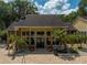 Exterior view of the clubhouse with manicured landscaping and brick and column accents at 8653 Fancy Finch Dr # 102, Tampa, FL 33614