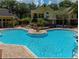 Expansive community pool area with clear blue water and attractive landscaping at residential building at 8653 Fancy Finch Dr # 102, Tampa, FL 33614