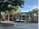 Brick apartment building with yellow siding, multiple balconies, and parking at 8653 Fancy Finch Dr # 102, Tampa, FL 33614