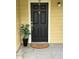 View of the front door with black paint and unit number 102 at 8653 Fancy Finch Dr # 102, Tampa, FL 33614
