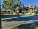 Community tennis court with fenced perimeter and residential apartment buildings in the background at 8653 Fancy Finch Dr # 102, Tampa, FL 33614