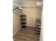 Walk-in closet featuring shelving and a rod, maximizing storage for clothing and accessories at 8653 Fancy Finch Dr # 102, Tampa, FL 33614