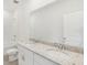 Bathroom featuring double sink vanity with granite countertop, walk-in shower, and a separate bathtub at 1869 Brekey Way, Zephyrhills, FL 33541