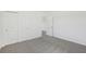 The home's carpeted bedroom features a double closet and an entryway to another room at 1869 Brekey Way, Zephyrhills, FL 33541