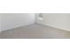 Bright bedroom features neutral carpet, white walls, window, and ample natural light at 1869 Brekey Way, Zephyrhills, FL 33541
