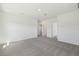 Spacious bedroom with neutral carpeting, base molding, and several entryways throughout the room at 1869 Brekey Way, Zephyrhills, FL 33541