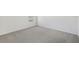 A home's carpeted bedroom features a single window allowing in natural light at 1869 Brekey Way, Zephyrhills, FL 33541