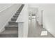 Entryway featuring hardwood flooring, a staircase, and an open floor plan with lots of light at 1869 Brekey Way, Zephyrhills, FL 33541