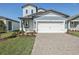 Charming two-story home featuring a two-car garage, nicely manicured lawn and stylish exterior paint at 1869 Brekey Way, Zephyrhills, FL 33541