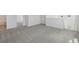 A home's carpeted hallway that features views into the main bathroom and staircase area at 1869 Brekey Way, Zephyrhills, FL 33541
