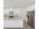 Eat-in kitchen features a center island, stainless steel appliances, and recessed lighting at 1869 Brekey Way, Zephyrhills, FL 33541