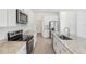 Spacious eat-in kitchen boasts stone counters, stainless appliances, and tons of cabinet storage at 1869 Brekey Way, Zephyrhills, FL 33541