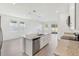 Open concept kitchen with granite counters, stainless appliances, and a center island with sink at 1869 Brekey Way, Zephyrhills, FL 33541