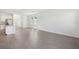 Large living room area with hardwood floors, lots of natural light and open to kitchen at 1869 Brekey Way, Zephyrhills, FL 33541