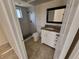 Stylish bathroom featuring a walk-in shower with stone floors and a granite-topped vanity at 89 Mark Twain Ln, Rotonda West, FL 33947
