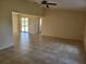 Spacious living room with tile flooring and high ceilings, offering a bright and airy atmosphere at 89 Mark Twain Ln, Rotonda West, FL 33947