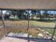View of backyard from patio with screen at 89 Mark Twain Ln, Rotonda West, FL 33947
