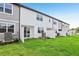 Townhome backyards with green lawns and white fences, perfect for outdoor enjoyment at 7270 Deer Valley Cir, Tampa, FL 33635