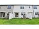 Townhome backyard with lush green lawn, white fences, and sliding glass door at 7270 Deer Valley Cir, Tampa, FL 33635