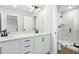 Modern bathroom features dual vanity, ample lighting, quartz countertop, and glass shower enclosure at 7270 Deer Valley Cir, Tampa, FL 33635