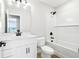 Bright bathroom featuring a white vanity, toilet, and shower with black hardware accents at 7270 Deer Valley Cir, Tampa, FL 33635
