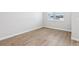 Bright, empty bedroom featuring wood-look tile flooring and natural light at 7270 Deer Valley Cir, Tampa, FL 33635